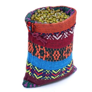 Detailed view of colorful ethnic pattern cotton pouch filled with green mung beans