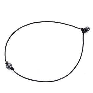 Detail of a black leather cord necklace with dark grey shell pearls and handmade knots