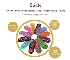 Close-up of colorful cotton socks with dense orange anti-slip silicone dots on the sole