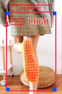 Close-up of non-slip grip dots on yellow cotton yoga socks with functional matrix design