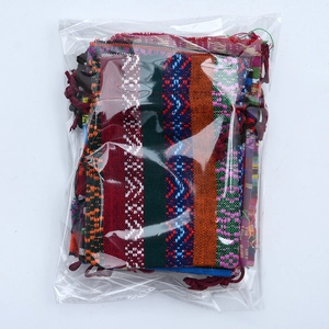 Detailed stack of colorful tribal pattern drawstring pouches in clear plastic packaging