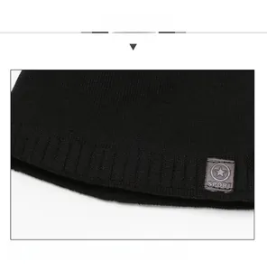 Close-up of black ribbed knit beanie with star sport leather patch detail