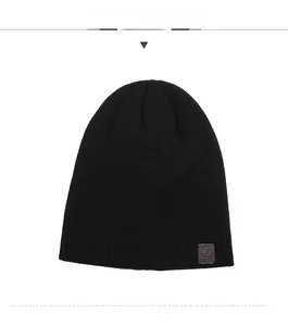 Detailed view of black knit beanie with sport leather patch and star pattern