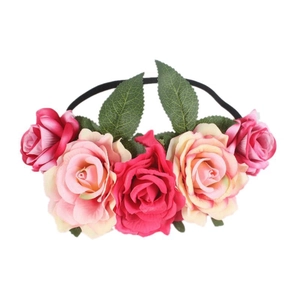 Detailed view of the fabric rose floral headband, showing vibrant petals and green leaves.