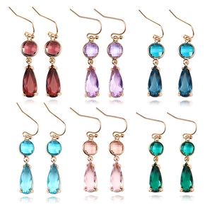 Macro detail of geometric drop earrings with colorful waterdrop crystals in six shades