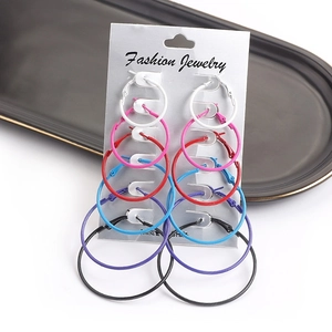 Set of six pairs of colorful hoop earrings in various sizes on a white display card