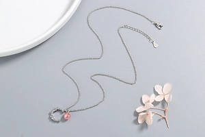 Macro detail of S925 sterling silver stamp on moon strawberry crystal necklace