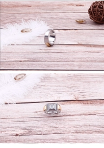 Detailed view of men's two-tone titanium ring with square zircon and strap patterns