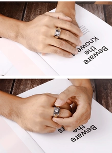 Detailed view of a silver and gold men's titanium ring with a square zircon inlay