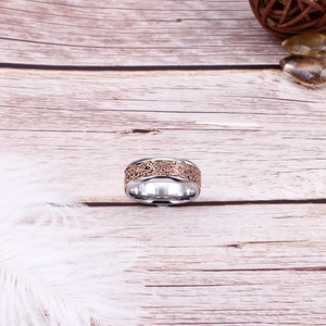 Minimalist silver and rose gold mixed metal ring with wire wrap texture on wood