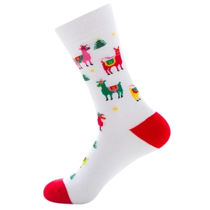 Detail view of a white Christmas sock with alpaca and tree patterns and red heel accents