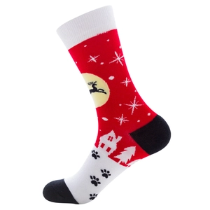 Close-up of Christmas socks featuring reindeer and snowflake patterns on red fabric
