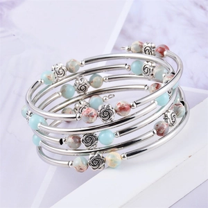 Close-up of bohemian multilayer beaded bracelet with silver roses and natural stones