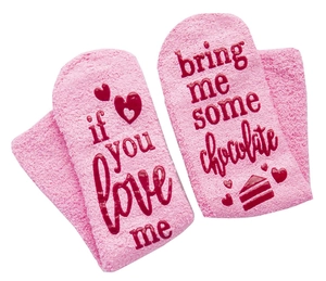 Pink plush socks with 'If you love me bring me some chocolate' text on the soles