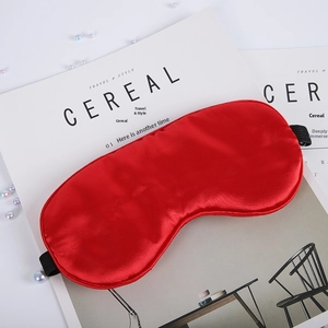 Detailed view of red satin silk sleep mask texture and high quality stitching details
