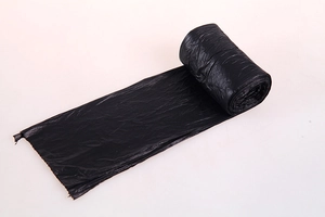 Detail view of thickened black roll-up kitchen trash bag with easy-tear perforations