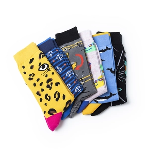 Detail of six pairs of men's crew socks featuring colorful patterns like sharks and leopard print