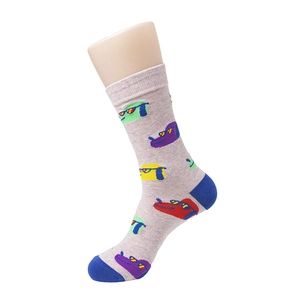 Detail view of light grey mid-calf cotton socks with colorful cartoon animal patterns
