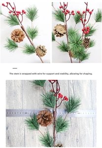 Detail of flexible pine needle stem with red berries and natural pine cones decoration