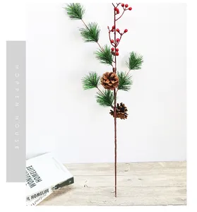 Detail of pine branch with red berries and cones for Christmas home decoration