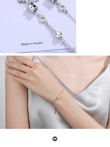 Detail of Korean style silver cylinder bead bracelet with high-polish metallic finish
