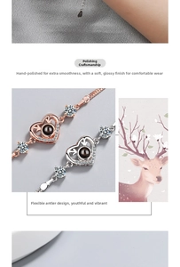 Macro detail of heart deer antler bracelet with 100 languages projection stone