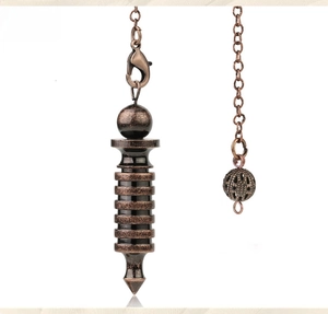Detailed macro view of vintage bronze healing pendulum with tiered spiral metal design