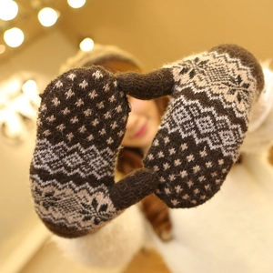 Thick knit mittens with Nordic snowflake patterns in warm brown and beige colors
