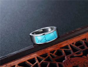 Macro detail of vintage silver steel ring featuring an emerald green cat-eye stone inlay