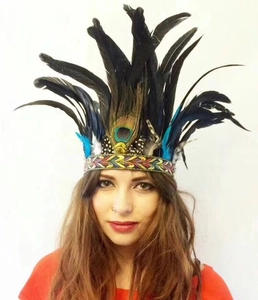 Detail of bohemian headpiece with black and peacock feathers on a braided band