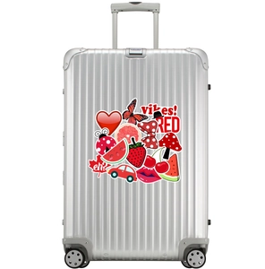 Silver metallic suitcase with vertical grooves and red aesthetic decorative stickers