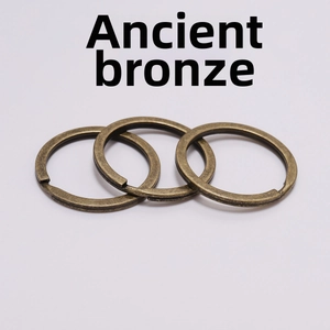 Macro shot of three antique bronze flat metal key rings for DIY jewelry and keychain crafts