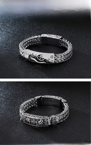 Detail of stainless steel 316L bracelets with gear relief and religious symbols