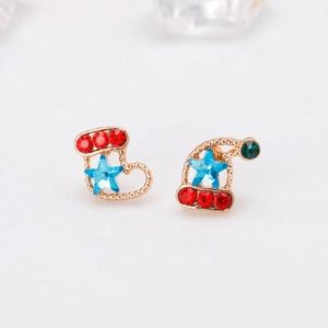 Detail view of asymmetric Christmas earrings with stocking and hat shapes and rhinestones