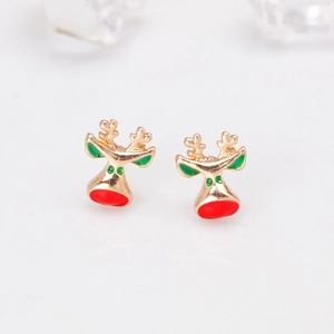Close-up of golden reindeer stud earrings with red and green enamel for Christmas