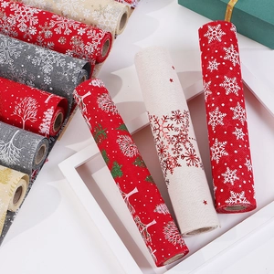 Christmas burlap table runner rolls with snowflake and tree patterns in festive colors