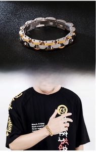 Detail of two-tone stainless steel men's bracelet with silver and gold linked segments