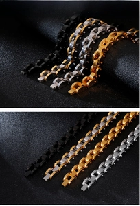 Detail of four-color stainless steel men's curb chain bracelets on a black display stand