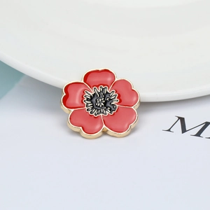 Cartoon red flower enamel brooch with golden metal edge on minimalist white background