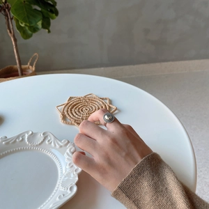 Close-up of 925 sterling silver vintage mirror ring with braided texture on finger