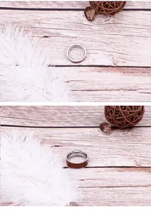 Detail view of silver stainless steel ring with brown wood inlay on a natural wooden surface