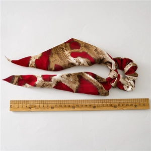 Animal print hair scrunchie with long ribbon streamer and size scale measurement