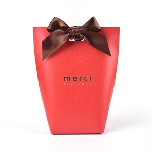 Elegant red gift box with brown satin bow and gold foil merci beaucoup lettering