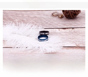 Macro detail of brushed stainless steel couple rings with diamonds on wood background