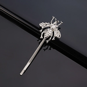 Macro shot of silver honey bee hair clip showing detailed wing textures and metallic finish