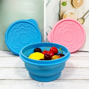 Blue foldable food-grade silicone bowl with textured lid containing fresh fruit models