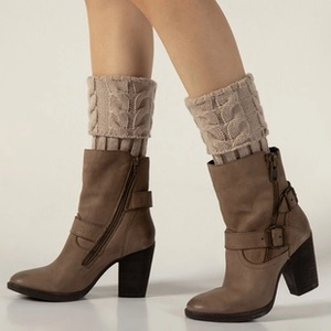 Close-up of khaki knitted leg warmers with cable knit pattern for winter boots