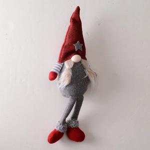 Christmas gnome plush decoration with red hat and grey stars on white background