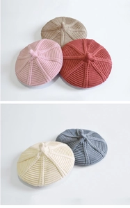 Detail showing various colors of knitted wool beret hats for children in thick soft yarn