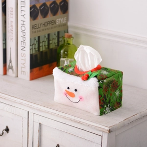 Christmas snowman tissue box cover with snowflake patterns on a festive wooden tabletop